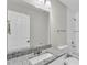 The bathroom features a granite countertop, framed mirror, and shower with white tile surround at 1025 Lakewood Ct, Lakeland, FL 33801