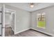 Light-filled bedroom with wood floors, window, and an open doorway to the hallway at 1025 Lakewood Ct, Lakeland, FL 33801