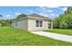 This freshly painted home offers a neat exterior, complemented by a well-maintained green lawn at 1025 Lakewood Ct, Lakeland, FL 33801