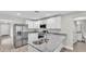 Well-lit kitchen boasts white cabinets, granite countertops, and stainless steel appliances at 1025 Lakewood Ct, Lakeland, FL 33801