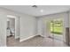 Bright living room featuring wood floors and sliding glass doors to the backyard at 1025 Lakewood Ct, Lakeland, FL 33801