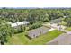 An aerial view showcases the back of a house surrounded by a green lawn and mature trees at 1025 Lakewood Ct, Lakeland, FL 33801
