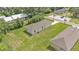 An aerial view shows the rear exterior of a light-colored single-story home and surrounding lawn at 1025 Lakewood Ct, Lakeland, FL 33801