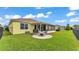 Spacious backyard with well-maintained lawn, circular patio with seating, and fenced-in boundary at 2472 Tahoe Dr, Lakeland, FL 33805