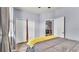 Bedroom featuring a four-poster bed with yellow throw, wood floors, and closet with double doors at 2472 Tahoe Dr, Lakeland, FL 33805