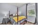 Cozy bedroom featuring a four-poster bed with a gray comforter, yellow throw, and window view at 2472 Tahoe Dr, Lakeland, FL 33805