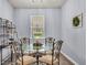 Cozy dining area features a round glass table, decorative metal chairs, and bright natural light at 2472 Tahoe Dr, Lakeland, FL 33805