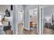 Hallway view of bathroom and living area featuring hard wood floors and neutral paint scheme at 2472 Tahoe Dr, Lakeland, FL 33805