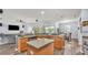Open kitchen features a breakfast bar with modern lighting, wood cabinets, and plenty of space at 2472 Tahoe Dr, Lakeland, FL 33805