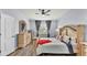 Spacious main bedroom features a decorative bed frame, light walls, ceiling fan, and hardwood flooring at 2472 Tahoe Dr, Lakeland, FL 33805