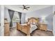 Main bedroom featuring a decorative bed frame, light walls, ceiling fan, and hardwood flooring at 2472 Tahoe Dr, Lakeland, FL 33805