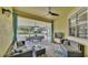 Covered patio featuring comfortable seating, ceiling fans, outdoor tv, and views of the backyard at 2472 Tahoe Dr, Lakeland, FL 33805