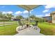 Backyard patio featuring two chairs, a small fire pit, and privacy fencing at 2472 Tahoe Dr, Lakeland, FL 33805