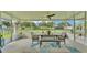 Covered patio featuring seating, table and bench, ceiling fan and screened-in enclosure at 2472 Tahoe Dr, Lakeland, FL 33805