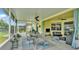 Covered patio featuring comfortable seating, ceiling fans, outdoor tv, table and bench and screened-in enclosure at 2472 Tahoe Dr, Lakeland, FL 33805