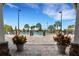 View of community pool with palm trees with patio and planters on a sunny day at 2472 Tahoe Dr, Lakeland, FL 33805