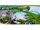 Community pool, playground, clubhouse, and tennis courts with a lake in the background create an inviting community atmosphere at 2472 Tahoe Dr, Lakeland, FL 33805