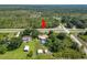 Aerial view of a home with a pool, surrounded by trees, and a shed at 2700 Park Ave, Indian Lake Estates, FL 33855