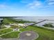 Beautiful waterfront park featuring a pier, gazebo, fountain, and an American flag waving proudly at 2700 Park Ave, Indian Lake Estates, FL 33855
