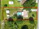 Expansive property with a pool, storage sheds, and lush greenery at 2700 Park Ave, Indian Lake Estates, FL 33855