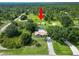 Aerial view of a home with a pool, surrounded by lush greenery, and a shed at 2700 Park Ave, Indian Lake Estates, FL 33855
