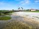 Charming beach with a quaint wooden bridge, a covered area, and soft sandy shores at 2700 Park Ave, Indian Lake Estates, FL 33855