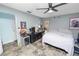 View of the bedroom with fan, desk, and full size bed at 2700 Park Ave, Indian Lake Estates, FL 33855