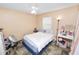 Cozy bedroom with a bed, side table, and natural light from the window at 2700 Park Ave, Indian Lake Estates, FL 33855