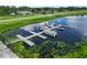 Picturesque dock with boats in the water, enhanced by lush aquatic plants and a secure fence at 2700 Park Ave, Indian Lake Estates, FL 33855