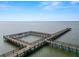Tranquil view of a lengthy pier stretching into the clear blue waters of a vast lake at 2700 Park Ave, Indian Lake Estates, FL 33855