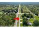 A long straight road runs through a lush, green landscape, with trees and clear skies above at 2700 Park Ave, Indian Lake Estates, FL 33855
