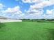 Expansive backyard showcasing lush green grass and a perimeter fence, providing privacy at 2811 Grandbury Grove, Lakeland, FL 33811