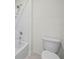 Bright bathroom featuring a white tiled shower and white toilet, offering a clean aesthetic at 2811 Grandbury Grove, Lakeland, FL 33811