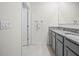 Modern bathroom with double vanity, granite countertops, and tiled floor at 2811 Grandbury Grove, Lakeland, FL 33811