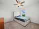 Comfortable carpeted bedroom featuring neutral décor, a platform bed, and scenic natural lighting at 2811 Grandbury Grove, Lakeland, FL 33811