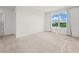 Well-lit bedroom with soft carpet, a window overlooking greenery, and a small table at 2811 Grandbury Grove, Lakeland, FL 33811