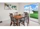 Cozy breakfast nook with a wooden table and chairs, next to sliding glass doors at 2811 Grandbury Grove, Lakeland, FL 33811