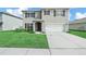 Charming two-story home featuring a well-manicured lawn and a two-car garage at 2811 Grandbury Grove, Lakeland, FL 33811