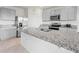 Modern kitchen featuring gray cabinetry, stainless steel appliances, and a large island at 2811 Grandbury Grove, Lakeland, FL 33811