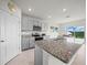 Bright kitchen with gray cabinets, granite countertops, and stainless steel appliances at 2811 Grandbury Grove, Lakeland, FL 33811