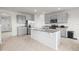 Modern kitchen featuring gray cabinetry, stainless steel appliances, and a large island at 2811 Grandbury Grove, Lakeland, FL 33811
