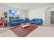 Spacious living room with modern blue sofas, large window, and stylish decor at 2811 Grandbury Grove, Lakeland, FL 33811