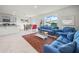 Spacious living room with modern blue sofas connected to the kitchen and dining area at 2811 Grandbury Grove, Lakeland, FL 33811