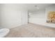 Upstairs loft area with neutral carpet, a window, and a view of the hallway at 2811 Grandbury Grove, Lakeland, FL 33811