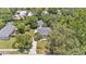 Aerial view of a home surrounded by mature trees and a detached garage with a driveway at 423 Avenue H Se, Winter Haven, FL 33880