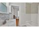 Bright bathroom featuring a marble vanity top, white tile and patterned mosaic tile detail above the tub at 423 Avenue H Se, Winter Haven, FL 33880