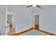 Cozy bedroom featuring hardwood floors and a ceiling fan at 423 Avenue H Se, Winter Haven, FL 33880