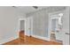 Bedroom with hardwood floors, ceiling fan, wallpaper and an open door leading to the bathroom at 423 Avenue H Se, Winter Haven, FL 33880