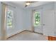Light and airy bedroom with hardwood floors and views of the yard at 423 Avenue H Se, Winter Haven, FL 33880