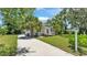 Charming home featuring a long driveway, lush lawn, and beautiful trees for curb appeal at 423 Avenue H Se, Winter Haven, FL 33880